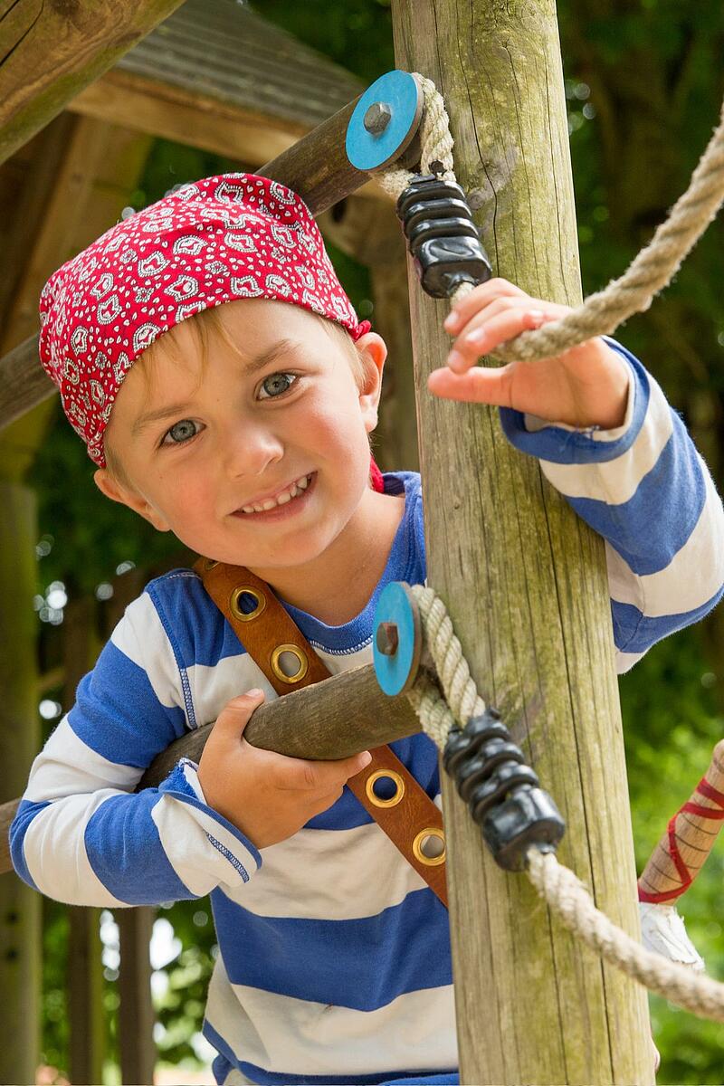 enfant jouant au camping de la Bien-Assise Petit garçon en train de jouer pendant ses vacances au camping de luxe la Bien-Assise
